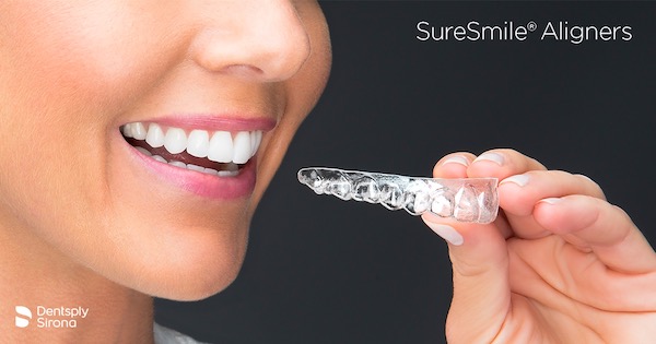 Person hold SureSmile aligners