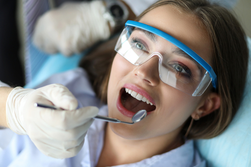 young female patient getting her teeth cleaned