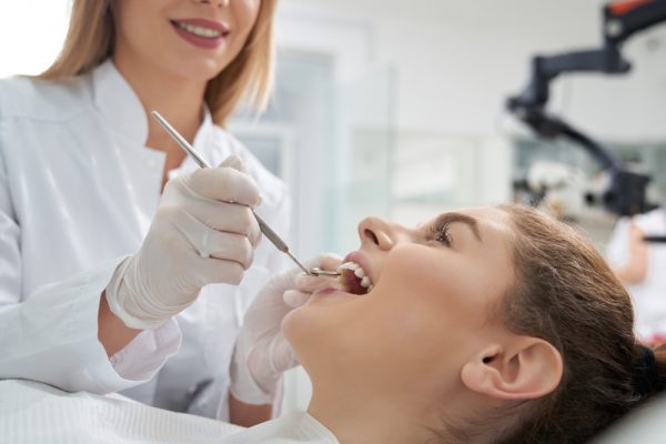 patient getting her teeth examined