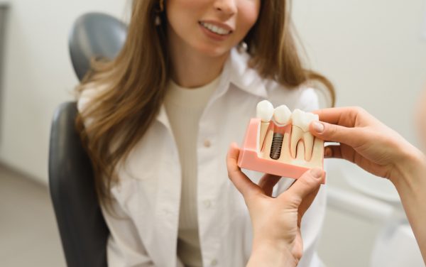 dentist showing patient how dental implants work