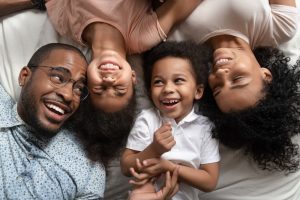 A family smiles after receiving a dental bonding treatment.