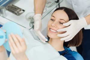 a woman finishes her routine dental cleaning